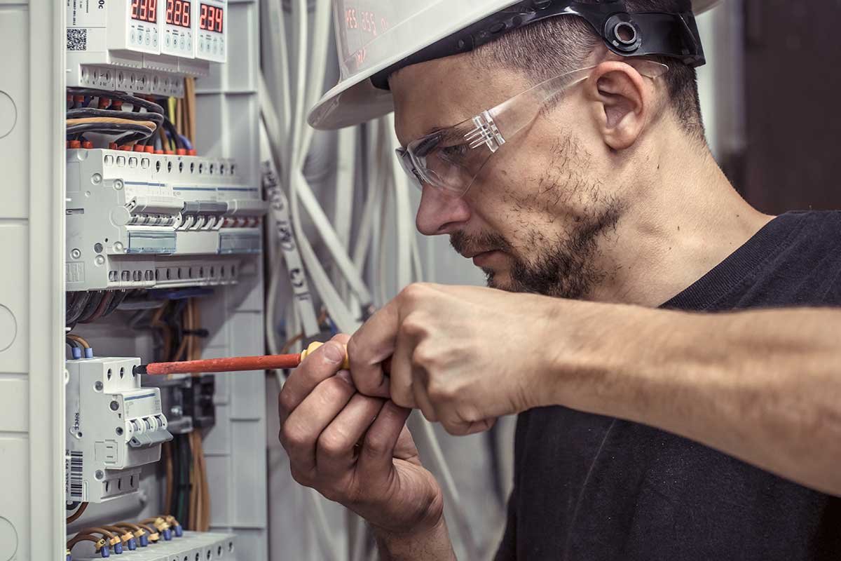 a-male-electrician-works-in-a-switchboard-with.jpg